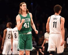 two basketball players are standing on the court