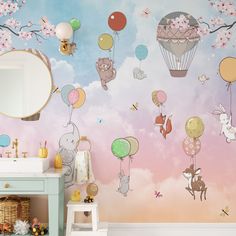 a child's room with balloons and animals painted on the wall, along with a mirror