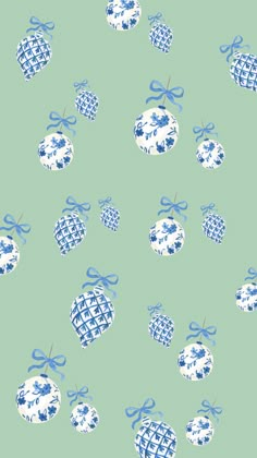 blue and white baubles with bows on a light green background seamless wallpaper