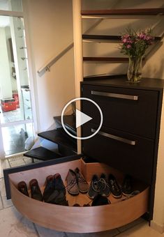 a bunch of shoes that are sitting in a shoe rack on the floor next to stairs