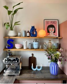 there is a coffee machine and vases on the shelf