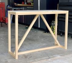 a wooden table sitting inside of a garage