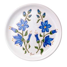 a white plate with blue flowers painted on it