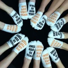 there are many white socks with orange words on them in the middle of a circle