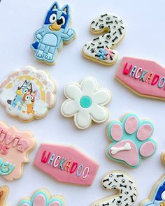 decorated cookies are arranged on a white surface