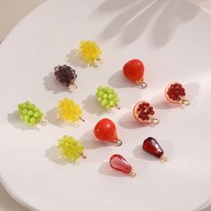 there are many different fruits and vegetables on the white plate, including grapes, oranges, raspberries, and grapefruit