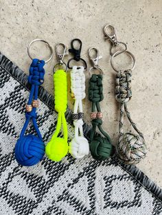 several different colored key chains on a rug