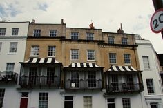 an apartment building with awnings and balconies