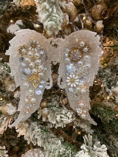 an angel ornament hanging from a christmas tree