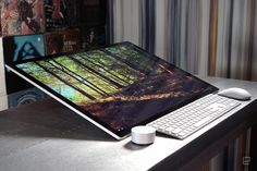 a laptop computer sitting on top of a desk next to a white mouse and keyboard