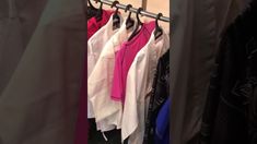 clothes hanging on a rack in a closet