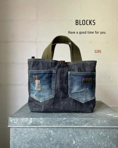 a handbag made out of jeans with the words blocks have a good time for you