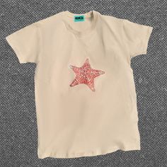 Inspired by the sand & sea. Designed by Katerina Skasi. Hand-printed in Exarcheia, Greece. 100% cotton. Beige T-shirt For Beach, Summer Season, Red Graphic Tee For The Beach, Red Relaxed Fit T-shirt For Beach, Star Tshirts, Striped Shorts Outfit, Orange Ocean, Star Tshirt, Sand Sea, Ocean Vibes