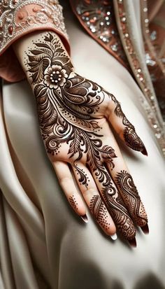 a woman's hand with henna on it