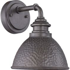 an old fashioned wall light with a metal shade