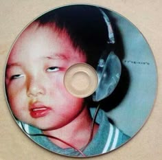 a cd with a child wearing headphones on it