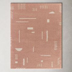 a square rug with an abstract design on the front and back of it in light pink