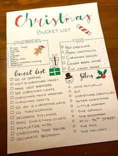 a christmas bucket list on top of a wooden table