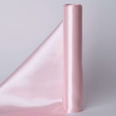 a roll of pink satin sitting on top of a table