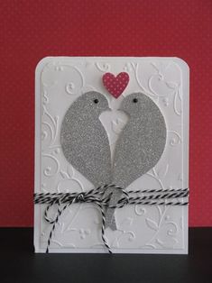 a card with two birds and a heart on it