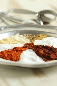 various spices are in a bowl on a table