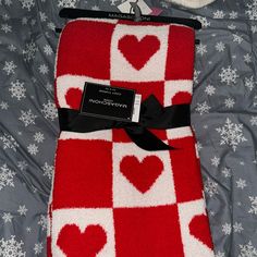 a red and white blanket with hearts on it