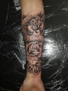 a black and white rose tattoo on the arm