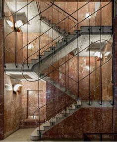 a staircase in an old building with glass railings