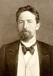 an old black and white photo of a man with a beard wearing a tuxedo