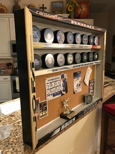 a display case filled with lots of different types of sports memorabilia on top of a counter