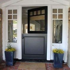 a front door with two planters on either side