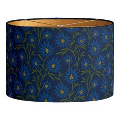 a blue lamp shade with green and yellow flowers on the bottom, hanging from a metal rod