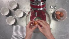 a person is making some food in a blender with eggs on the table next to them