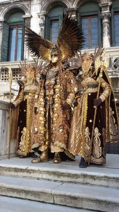 two men dressed in costume standing on steps