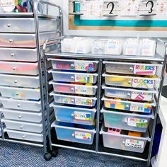 several plastic drawers are stacked on top of each other in this classroom storage unit area