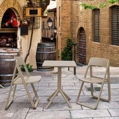 two chairs and a table in an alleyway