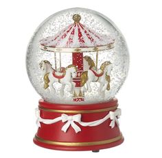 a merry go round snow globe with horses