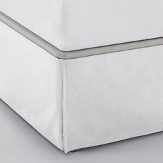 the bottom side of a bed with white sheets