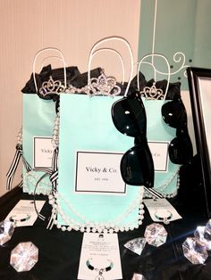 a table topped with bags and jewelry on top of a black table covered in cards