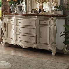 a large white dresser sitting in front of a mirror