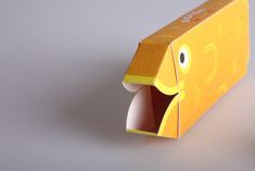 an open yellow box with a face on it's side and mouth wide open