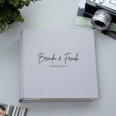 a book with the words, brand & frank written on it next to a camera