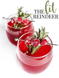 two glasses filled with red liquid and garnished with rosemary