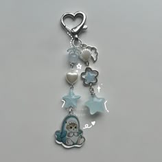 a keychain with an owl and stars on the front hanging from it's side