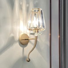 a wall light with a glass shade on it