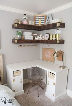 a white desk with shelves above it and some pictures on the wall in front of it