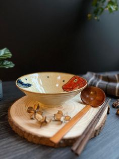 a bowl and spoon sitting on top of a wooden table