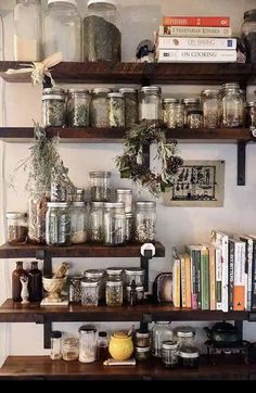 the shelves are filled with jars and books