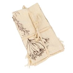 two napkins tied together on top of each other with flowers and leaves drawn on them