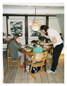 a group of people sitting around a wooden table